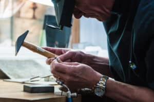 Jewellery craftsman examining platinum ring